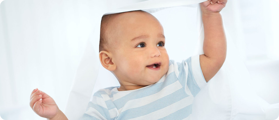 a happy baby playing